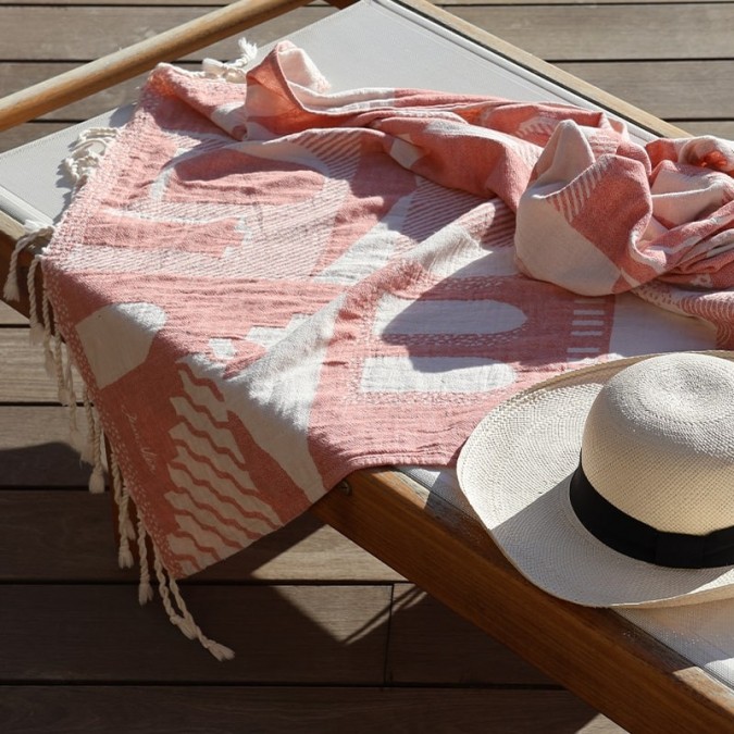 Trendy terracotta red absorbent fouta with Mediterranean style graphics