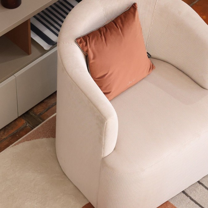 Trendy, high-quality beige rounded designer armchair