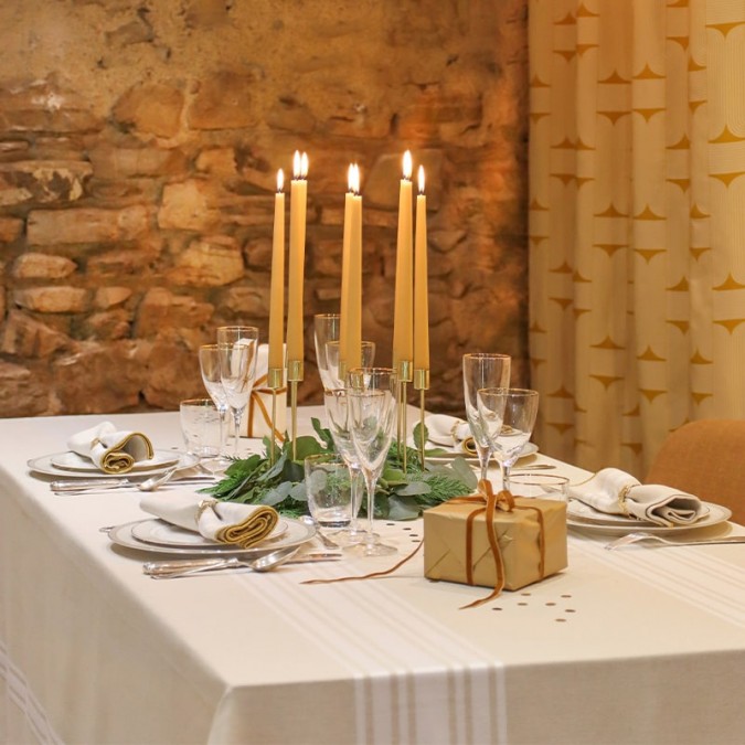 Simple, uncluttered beige and white striped tablecloth with gold embroidery