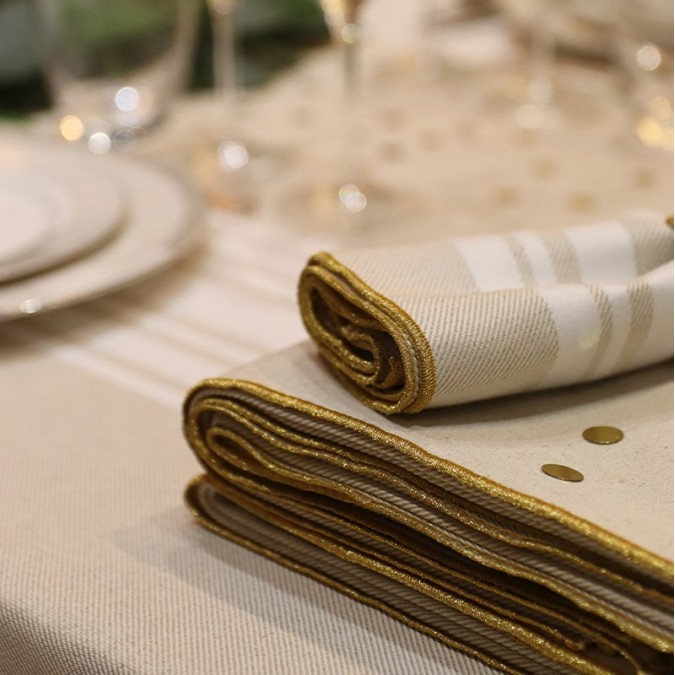 Beige cotton tablecloth with white stripes and gold embroidery