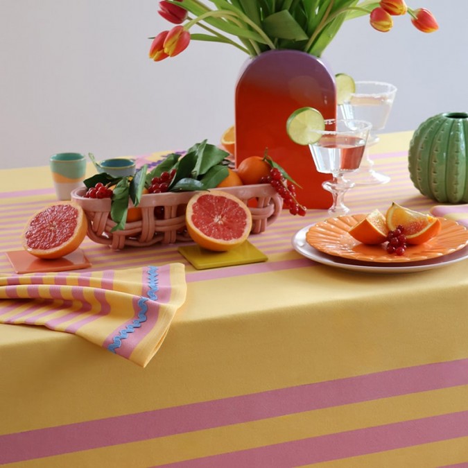 Trendy and colourful tablecloth in orange and pink stripes, stain-resistant