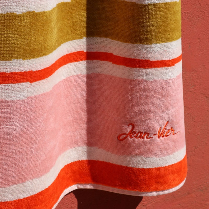 Beach towel with stripes and trendy red, green and pink lettering